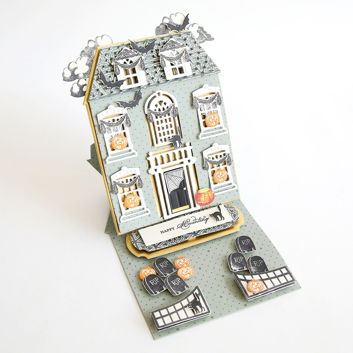 a card with a house made out of paper.
