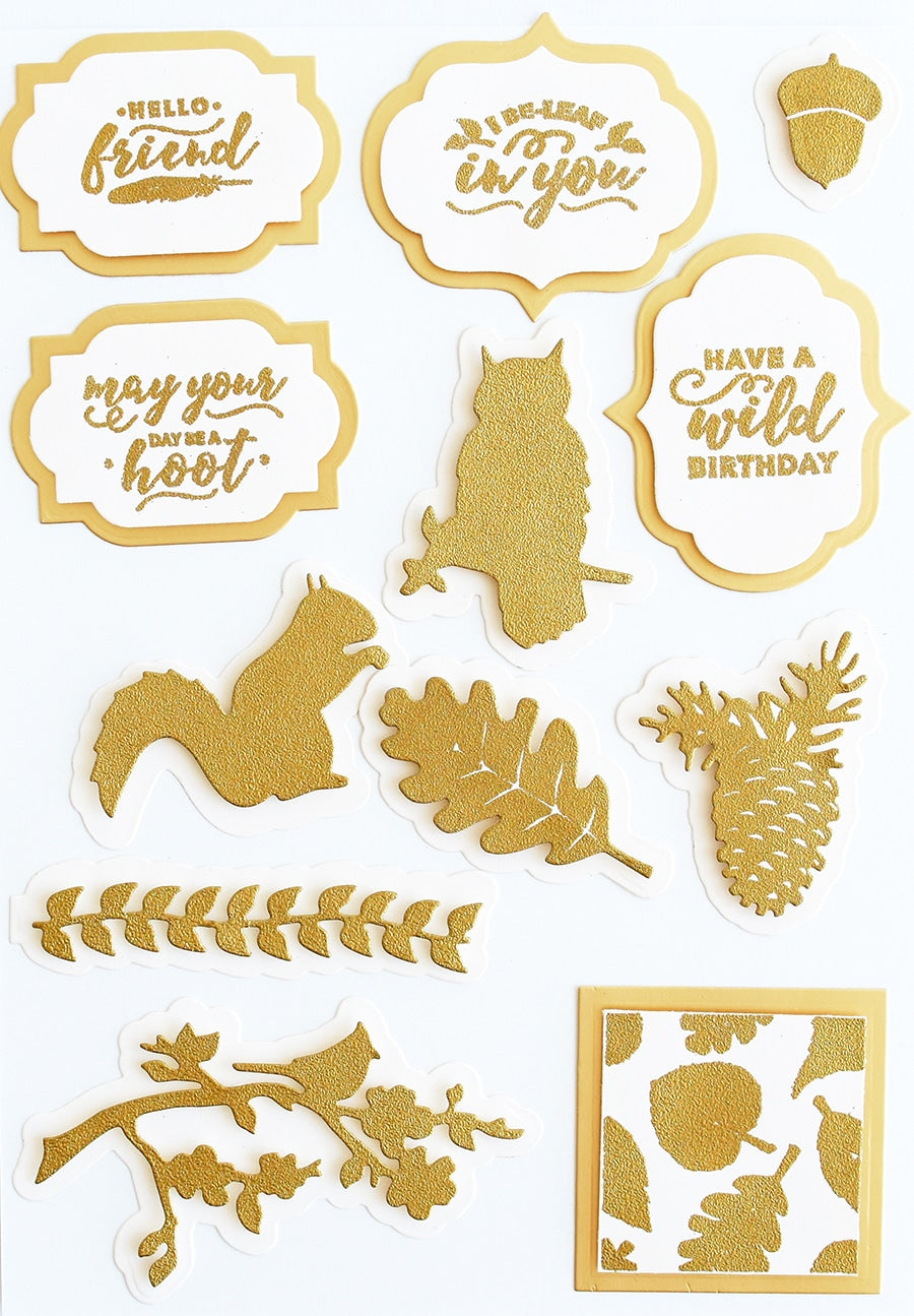 a bunch of gold stickers on a white surface.