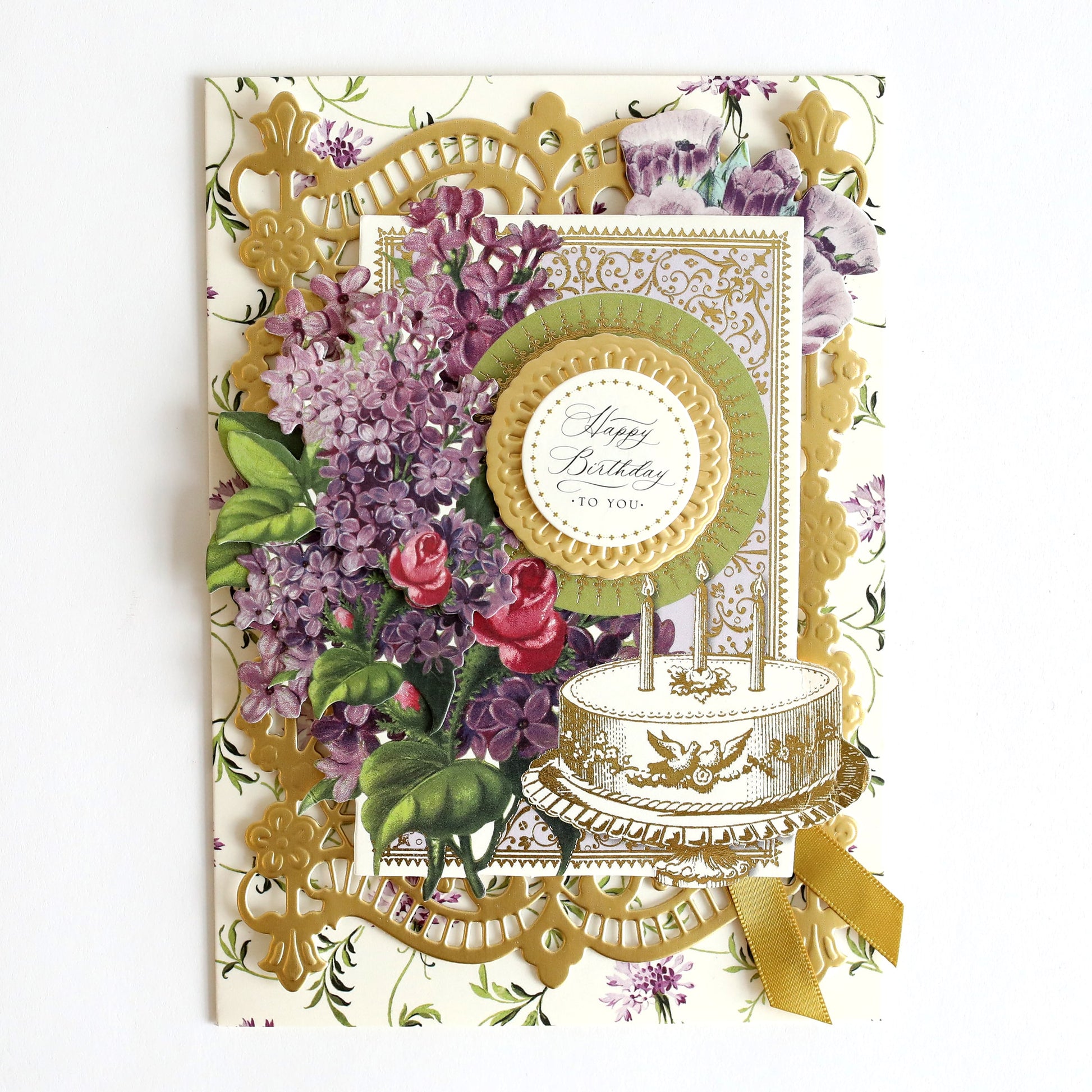 a card with a cake and flowers on it.