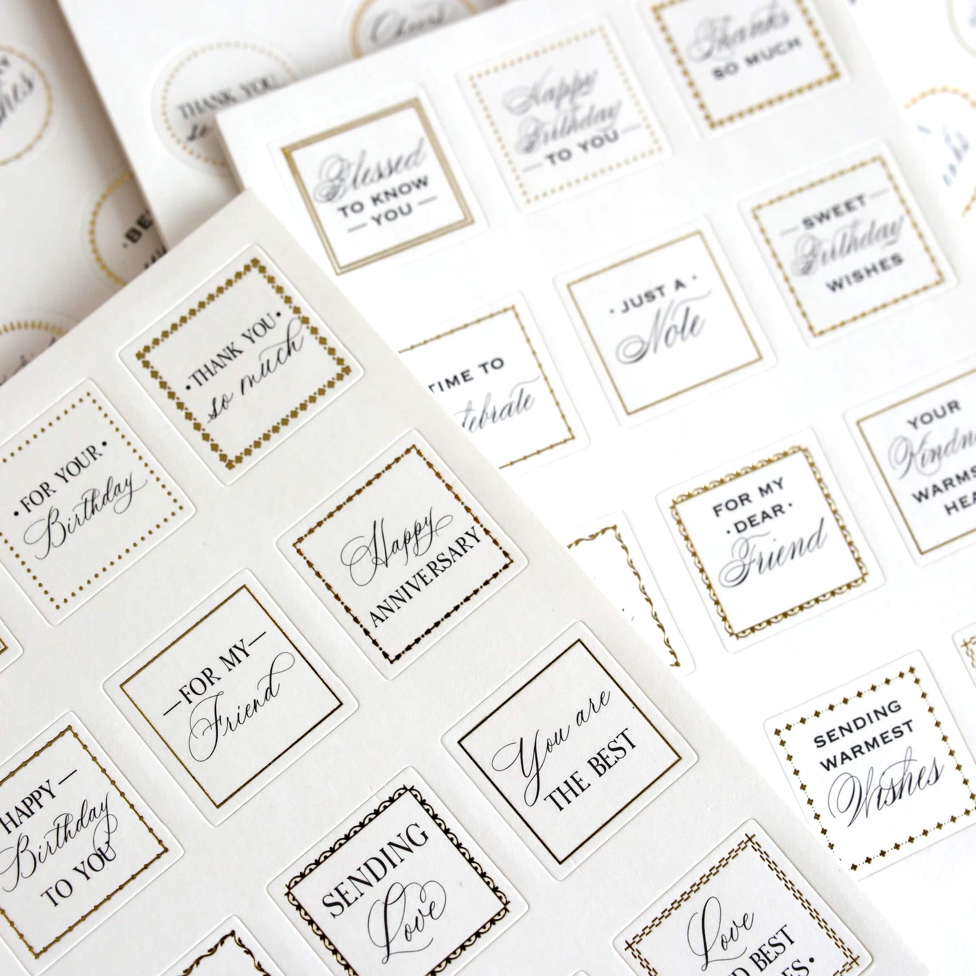 a table topped with lots of white and gold stickers.