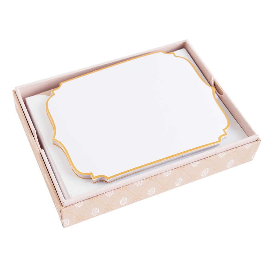 a pink and gold box with a white card inside.