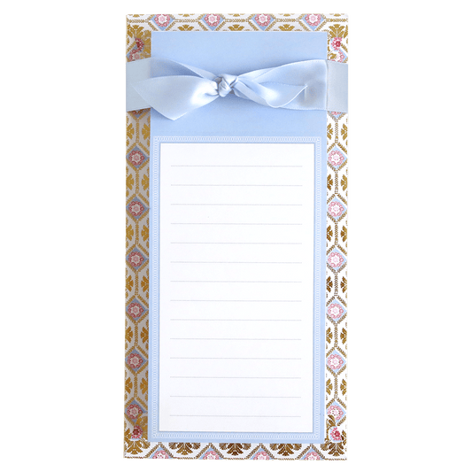 a notepad with a bow on top of it.