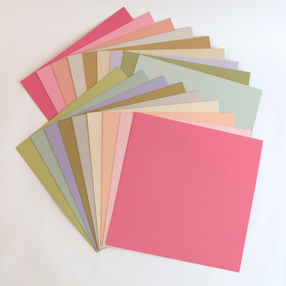 a bunch of different colors of paper on a table.