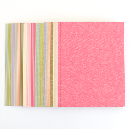 a close up of a book with a pink cover.
