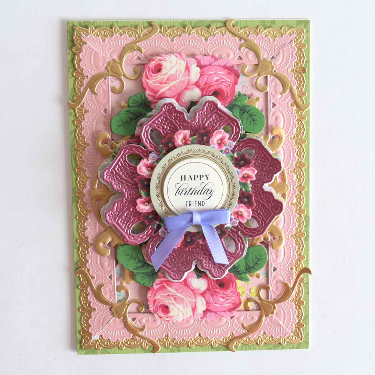 a pink and green card with flowers on it.