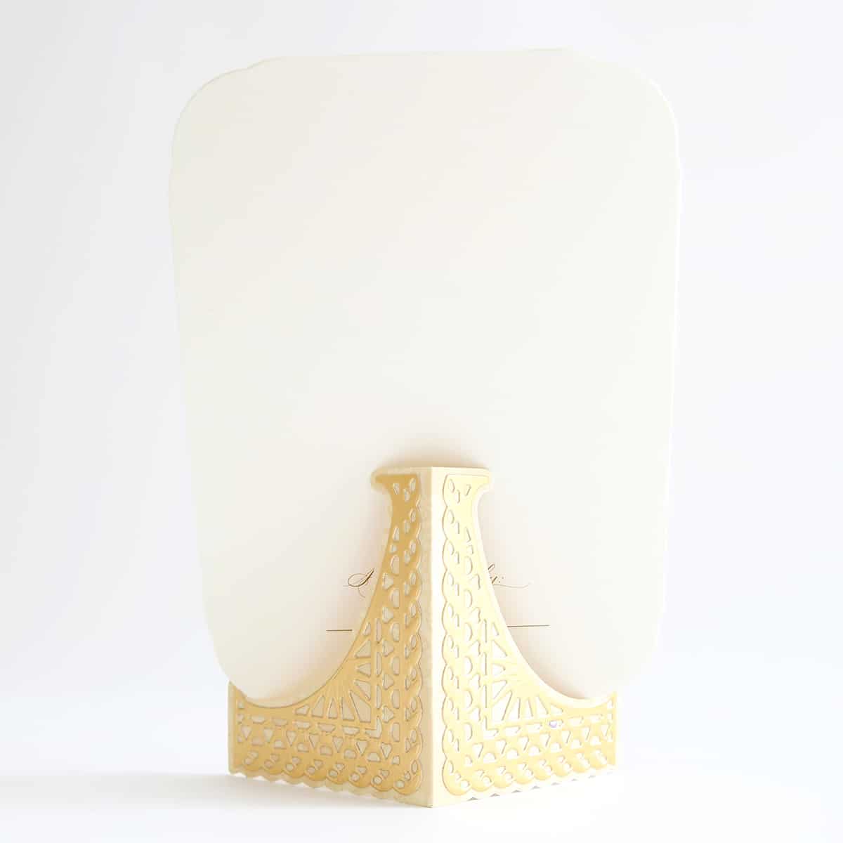 a white object with a gold base on a white background.