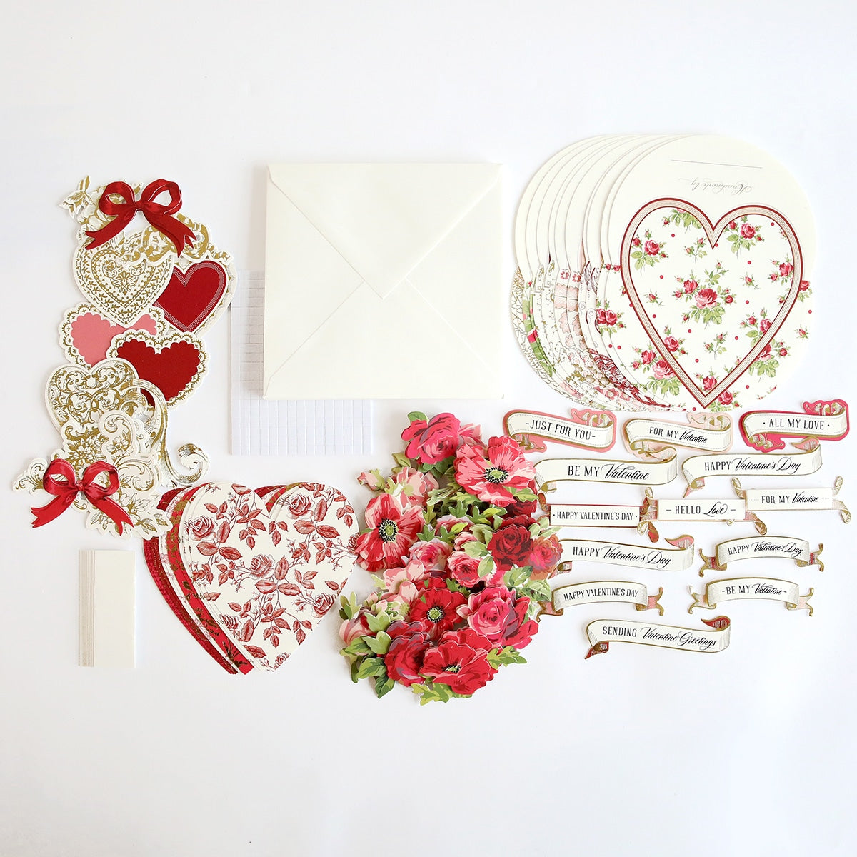 a table topped with lots of paper and flowers.