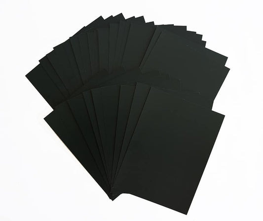 a stack of black cards sitting on top of each other.