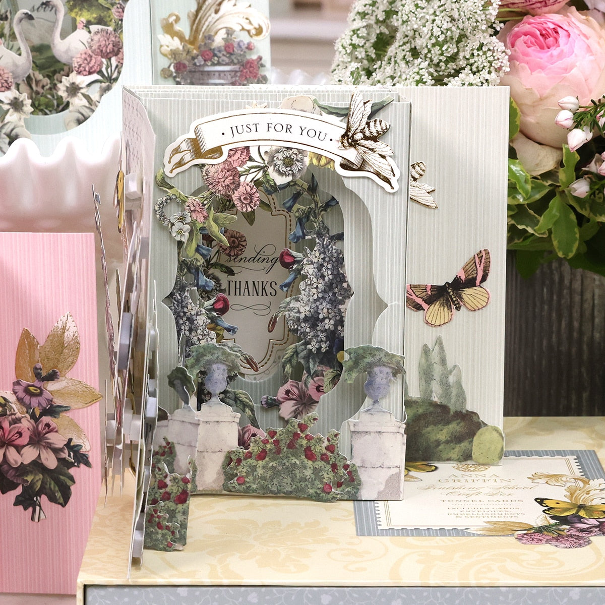 a table topped with lots of cards and flowers.