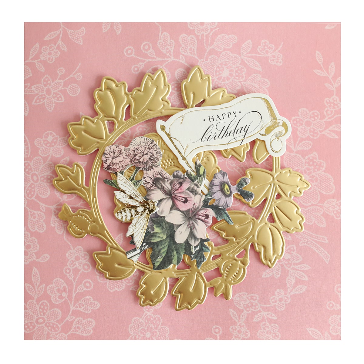 a pink and gold birthday card with flowers.