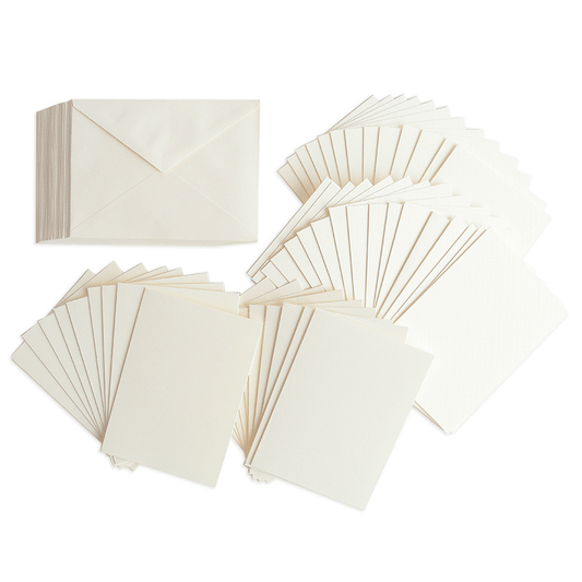a bunch of white cards and envelopes on a green background.