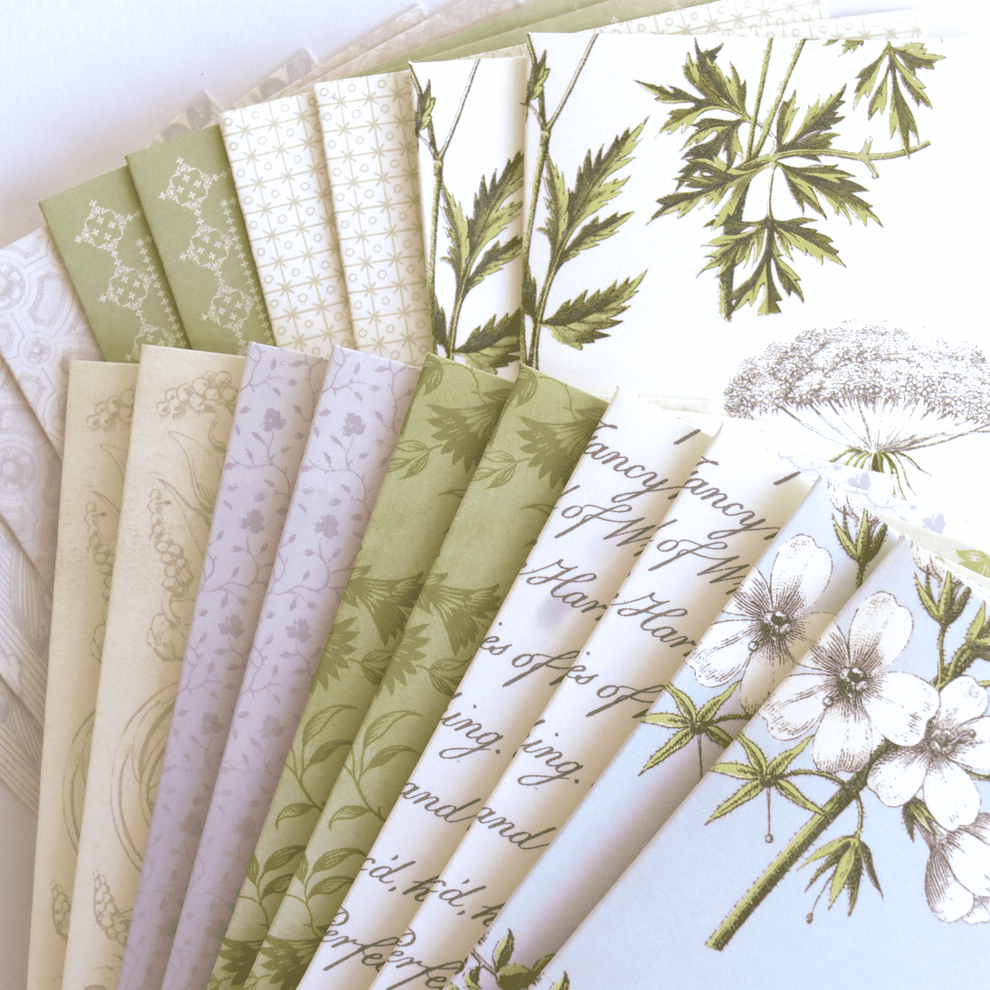 a bunch of papers that have flowers on them.