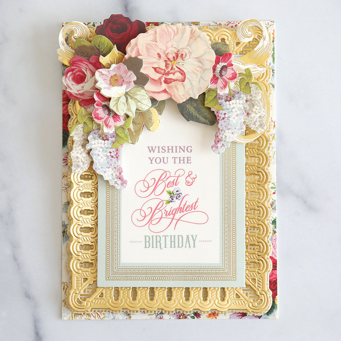 Card that has heavy, floral top, gold frames and rub on sentiment