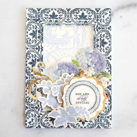 Navy blue stamped frame card with blue floral collage