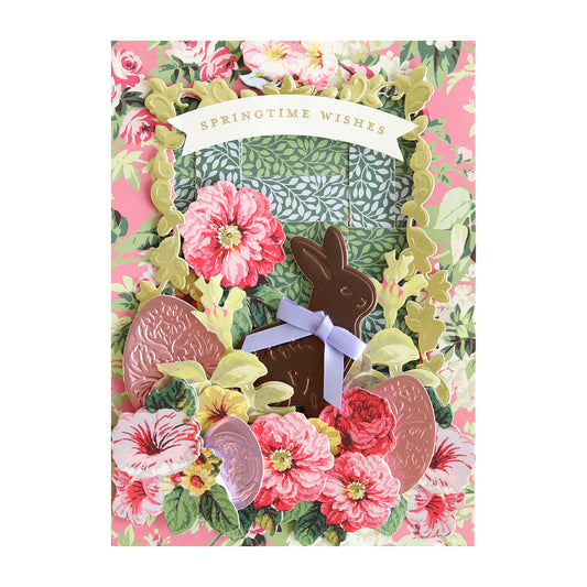 a greeting card with a bunny surrounded by flowers.