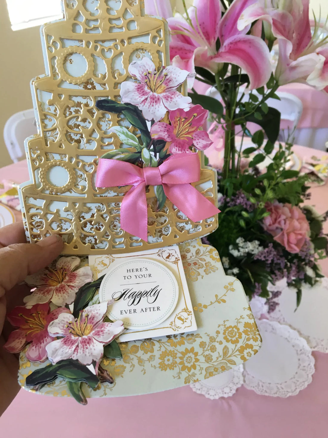 a person holding a card with flowers on it.