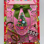 A christmas card with a pink tree and green ribbon.