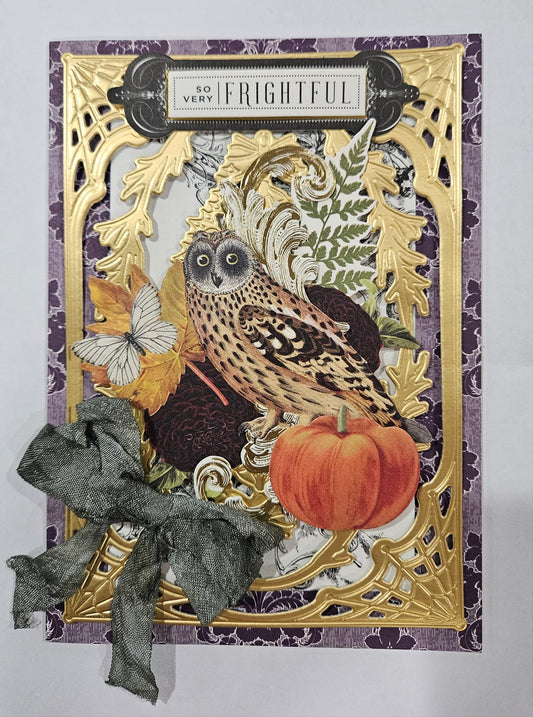 A card with an owl and pumpkins on it.