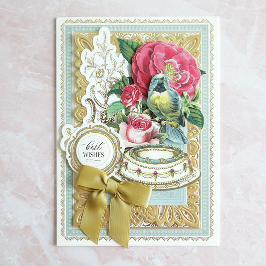 White and blue birthday card with roses, birds and a gold bow.