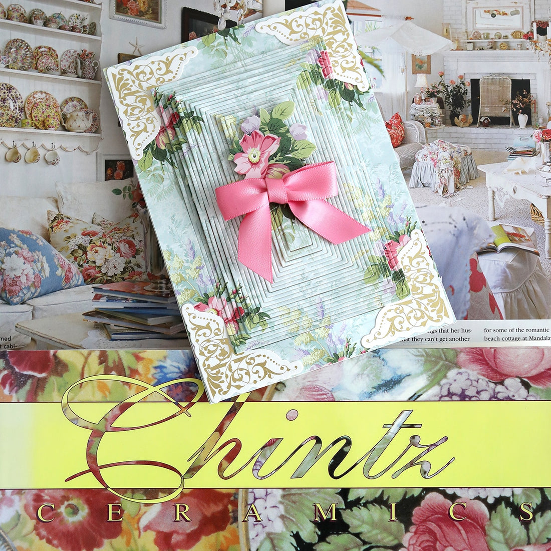 A card with a pink bow and flowers on it.