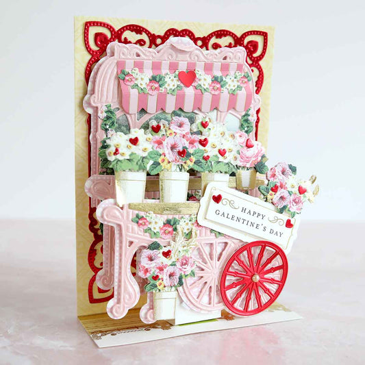 a pink and white card with a red wagon.