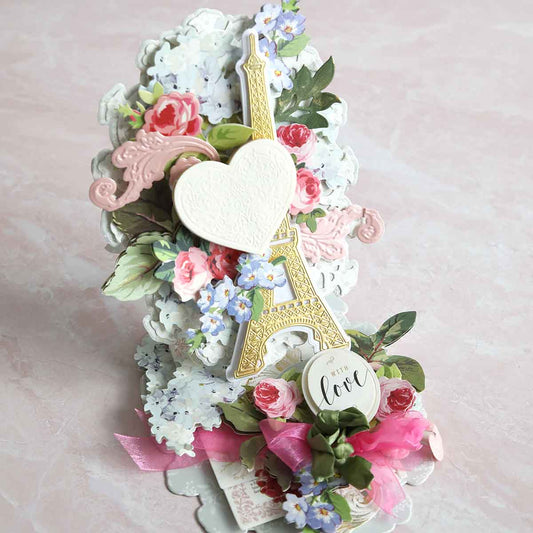 a close up of a card with flowers and a eiffel tower.