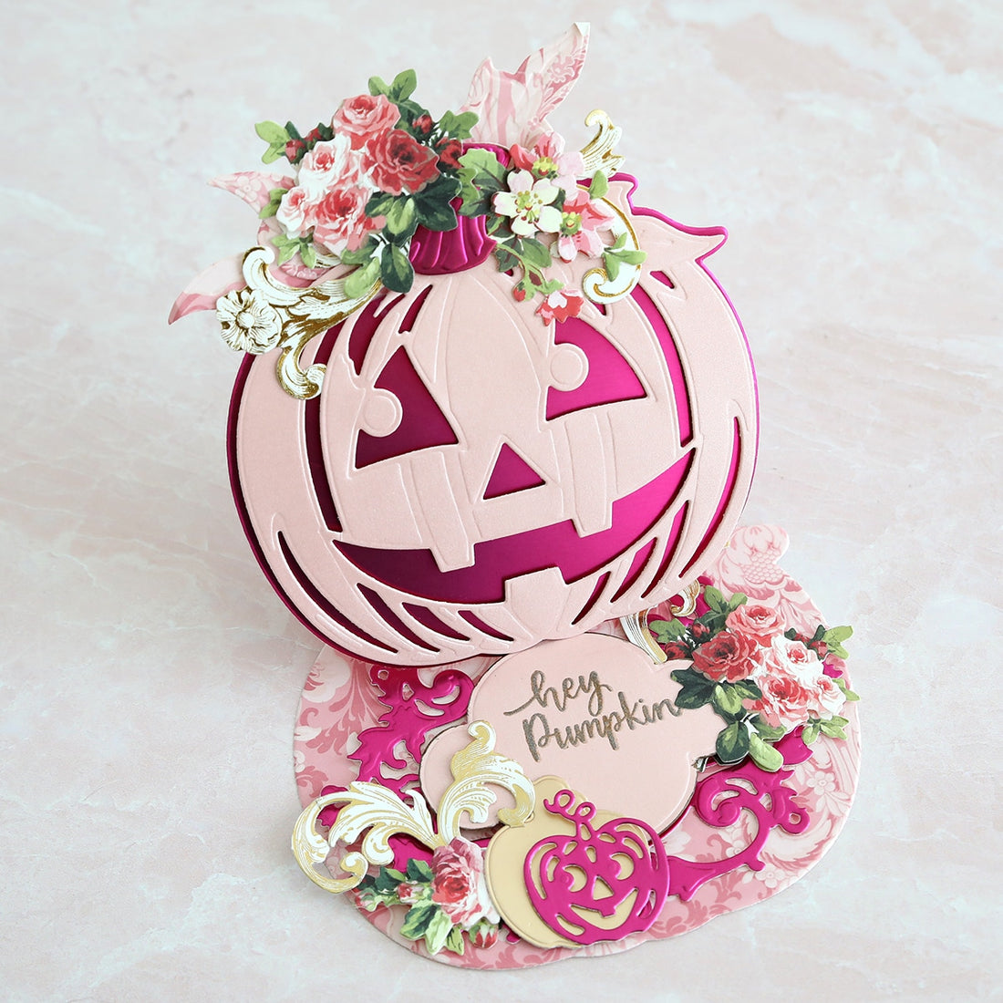 A pop up card with a jack o lantern and flowers.