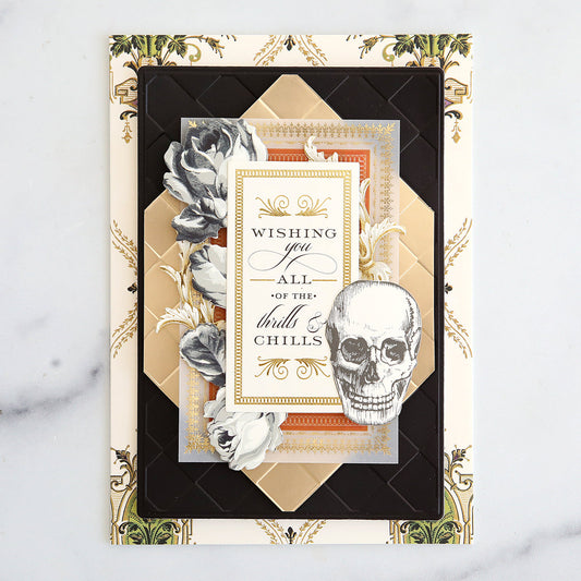 Halloween card with fussy cut Spellbound layers, vellum, a skull and black and cream flowers