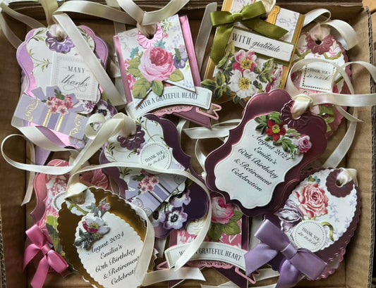 A collection of birthday and thank you tags with flowers and ribbon
