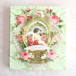 Elaborate green card box with mirror, flowers and cherub