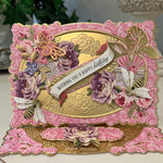 Pink and gold birthday easel card with pink and purple flowers.