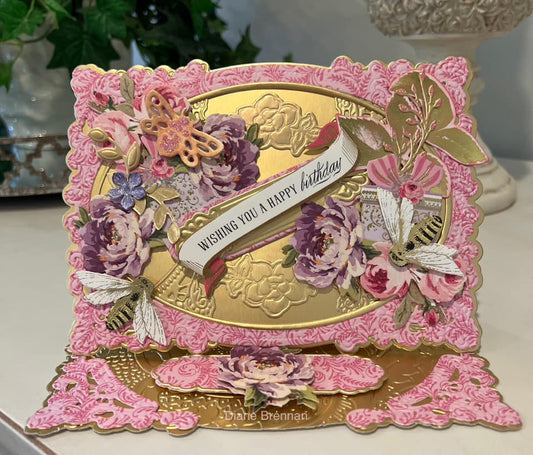 Pink and gold birthday easel card with pink and purple flowers.