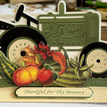 Green and black tractor with bounty of vegetable stickers