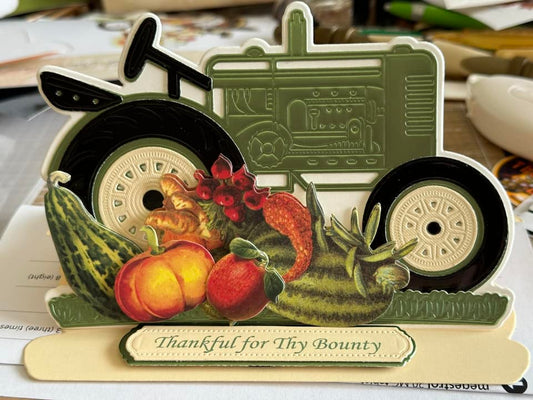 Green and black tractor with bounty of vegetable stickers