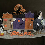 Halloween themed village with various spooky papers and embellishments