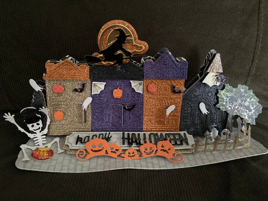 Halloween themed village with various spooky papers and embellishments