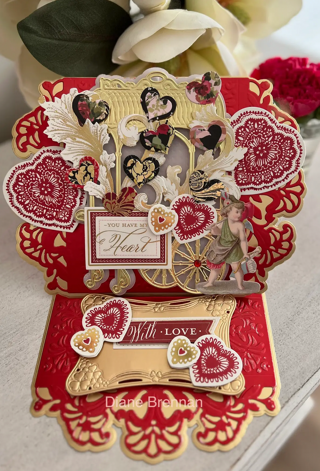 a close up of a card with flowers in the background.