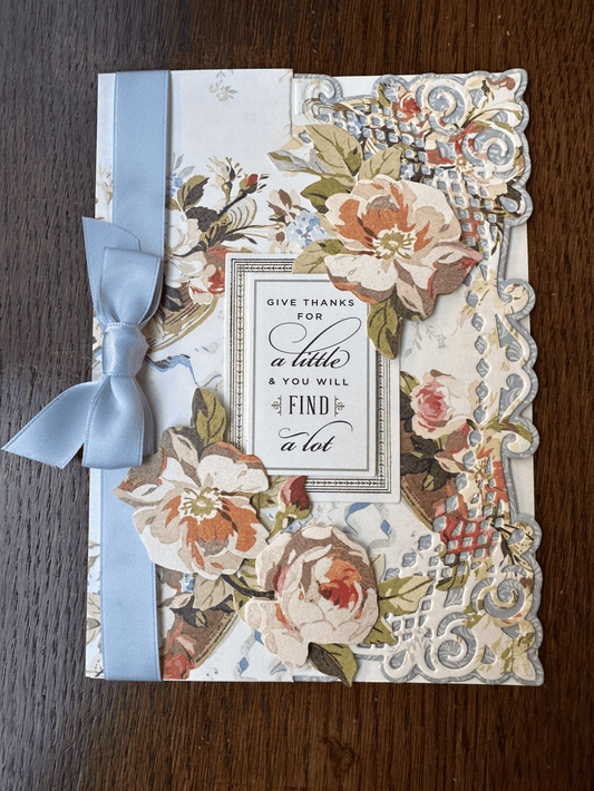 a card with flowers and a bow.