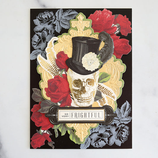 Black card with white rub on roses, rose stickers and a skull collage