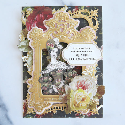 Black floral card with gold frame, paper doll sticker and flowers.