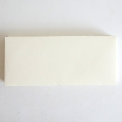 A 25 Pack of Natural Envelopes (4.125" x 9.5") rests on a white surface, its simple rectangular design reminiscent of Classic Crest envelopes.