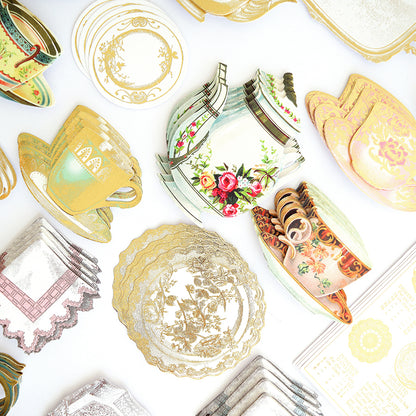 A collection of 120 Favorite Tea Embellishments, featuring assorted vintage-style paper cutouts of teapots, teacups, saucers, and lace doilies, is arranged on a white surface—creating charming sticker accents perfect for handmade cards or as antique tea stickers for all your crafts.