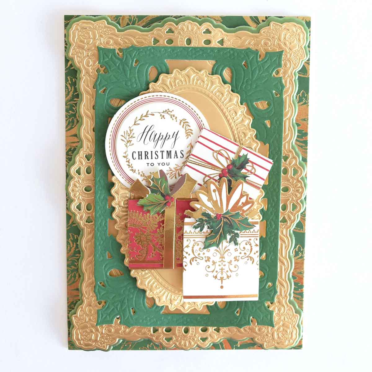 Reason for the Season Sticker Bundle featuring a decorative Christmas card with layered frames, a circular “Happy Christmas to you” sentiment, and dimensional embellishments of three holly-adorned gifts.