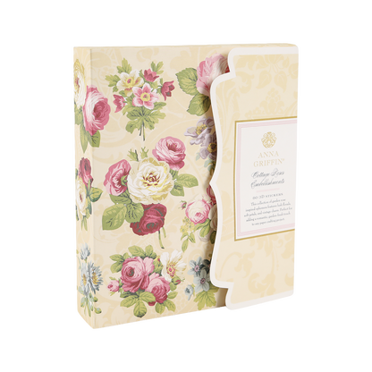 Decorative box with a scalloped edge, featuring a floral pattern and filled with assorted stationery and the delightful Cottage Roses Embellishments from Anna Griffin’s “Cotton Pass” collection.