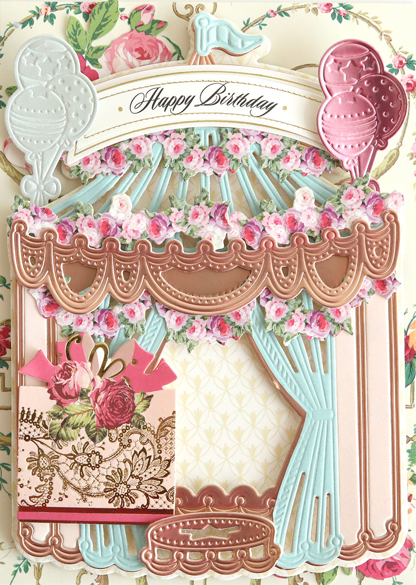 A decorative birthday card with a 3D Circus Tent Dies theme, featuring floral elements, pastel colors, and three-dimensional embellishments.