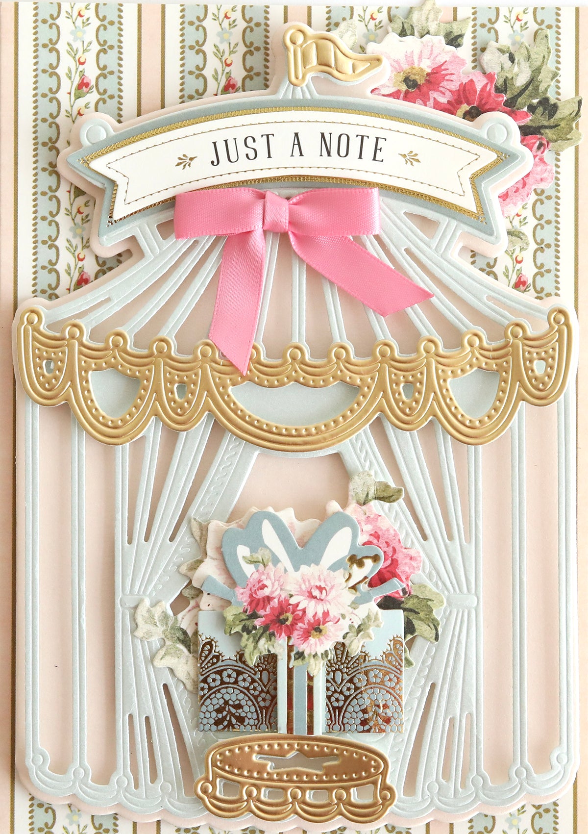 Decorative greeting card with a vintage birdcage design, floral embellishments, and a "just a note" banner, crafted with the 3D Circus Tent Dies die set.