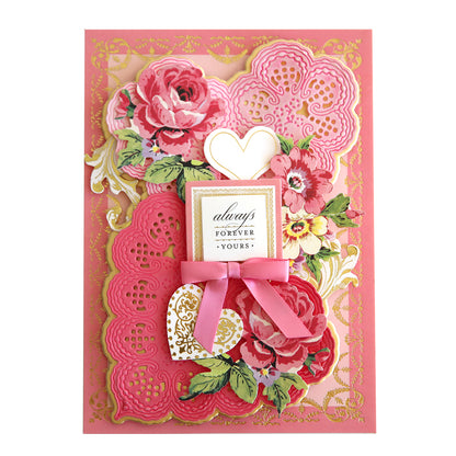 A romantic Valentine's Day card adorned with delicate pink flowers and a dainty ribbon, exuding an antique feel with the use of 3D Lace Doily Dies.