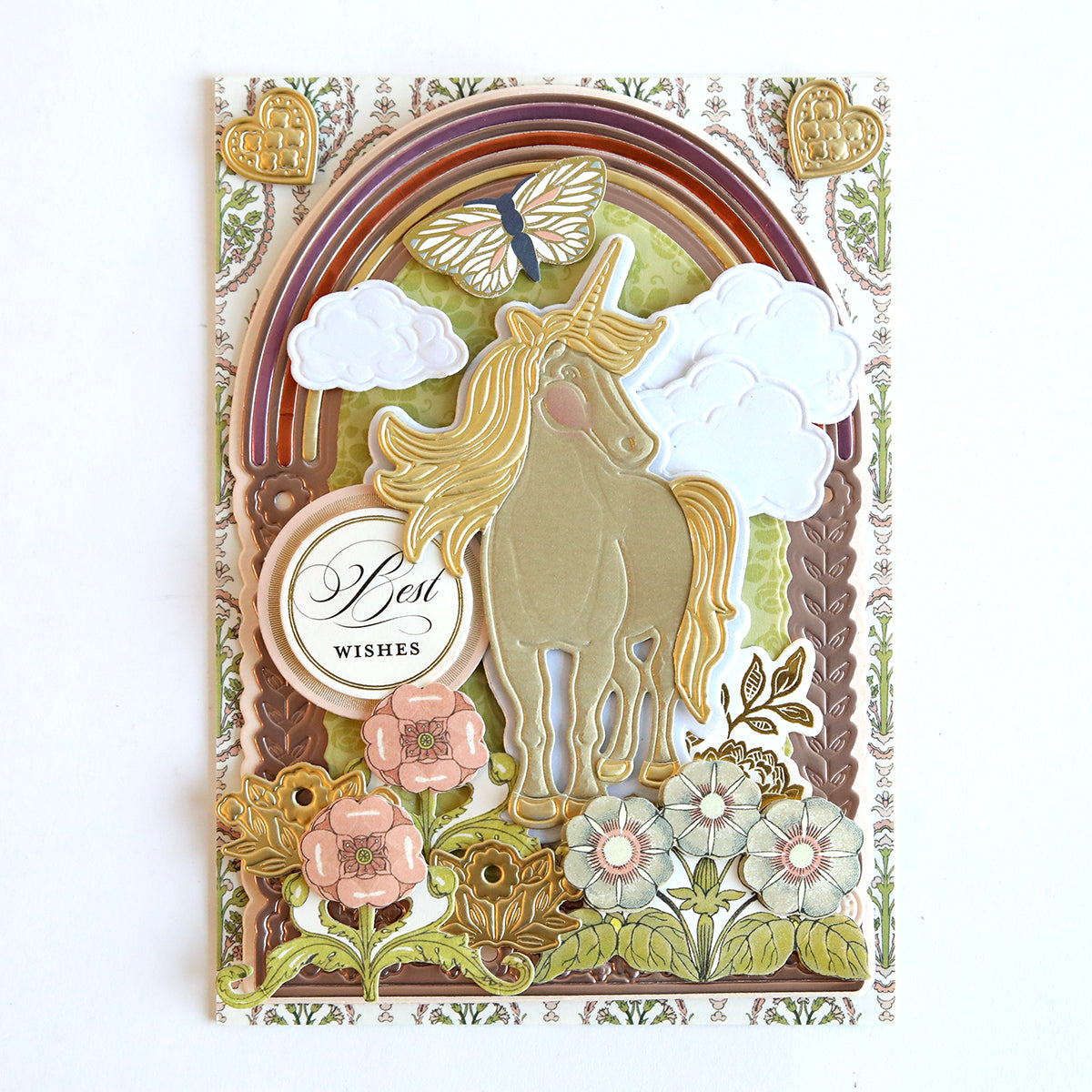 A handmade greeting card featuring a 3D Unicorn Scene Dies with unicorns, clouds, flowers, and the words "best wishes".