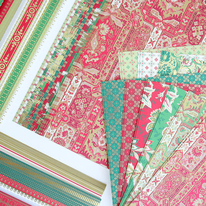 Colorful sheets of patterned cardstock from the Jasmine Holiday Papercrafting Kit, featuring red, green, and gold designs with floral, geometric, and ornate motifs, are arranged on a white surface. These festive patterns create the perfect atmosphere for adding special embellishments to your holiday projects.