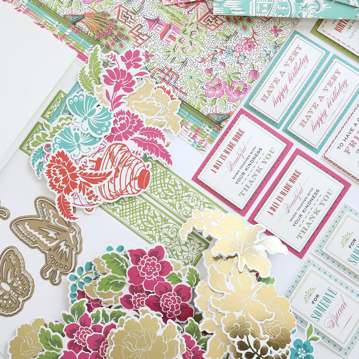 The Chinoiserie Papercrafting Kit with Dies includes floral and butterfly cut-outs, patterned papers, and labels with messages like “Have a very happy birthday” and “Thank you”—ideal for handmade cards or scrapbooking.